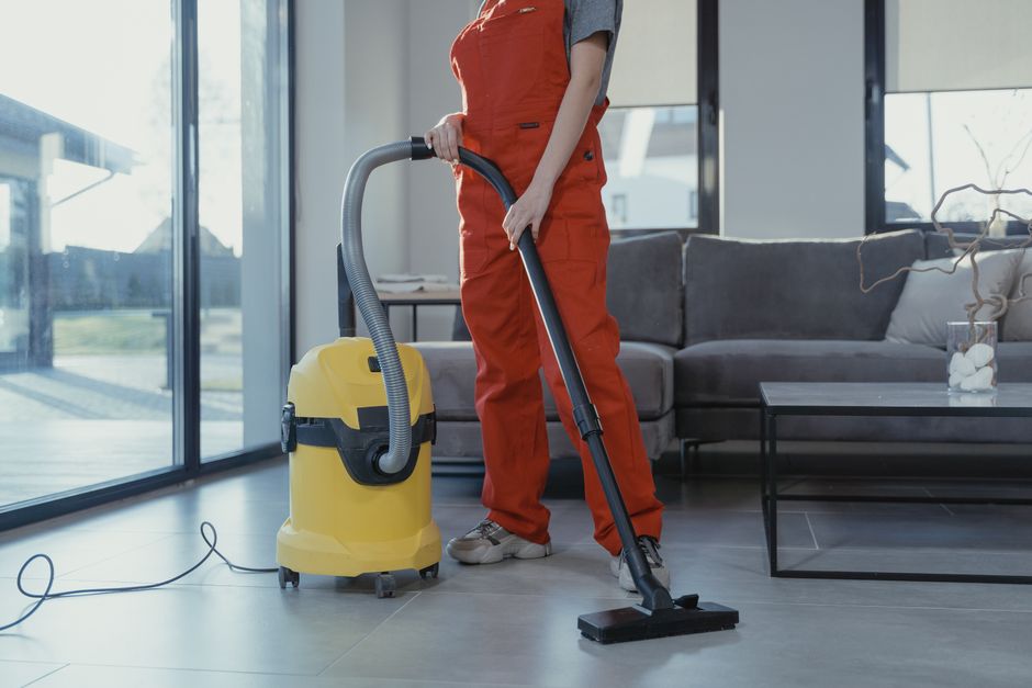 Professional cleaning service worker assessing a floor